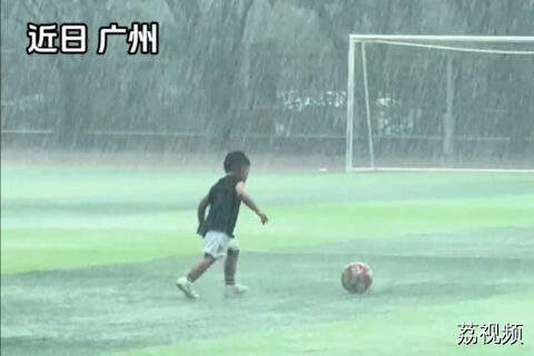 广东一小朋友暴雨中踢球